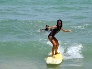 Girl Surfing With Instructor